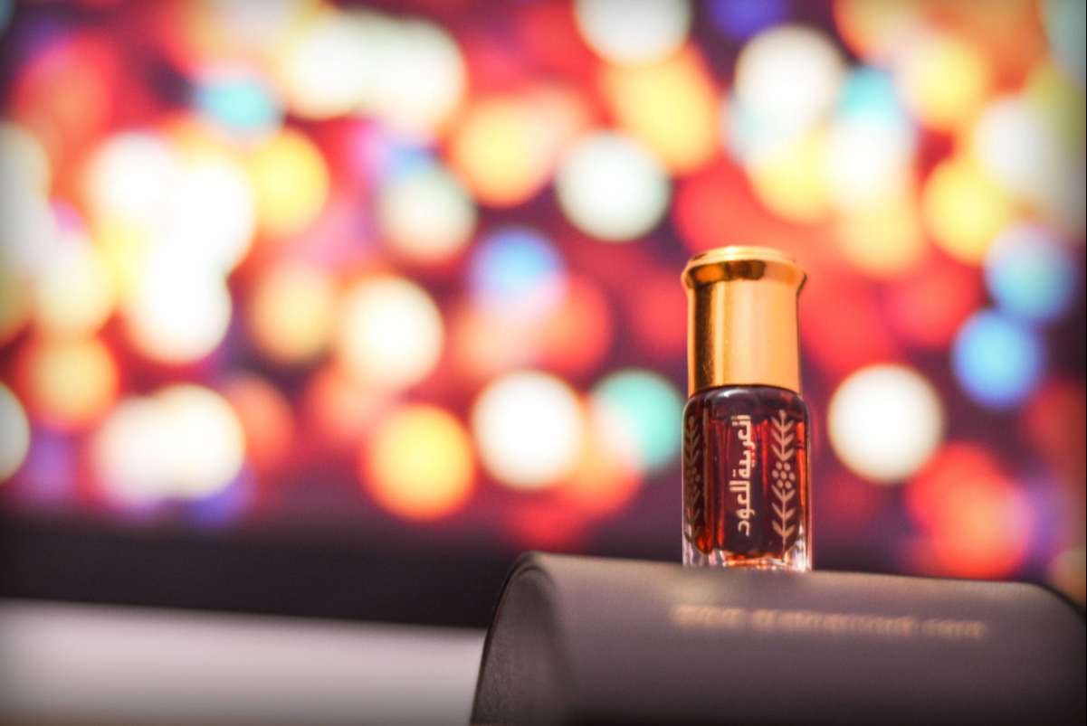 Elegant oud perfume bottle showcasing the Best Bakhoor for Kuwaiti Weddings in a festive setting